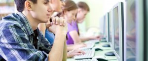 group-of-people-at-computer-stations-looking-at-computers